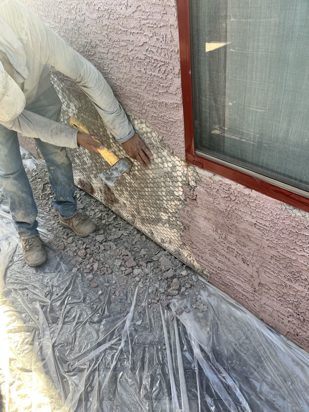 Shield Coat crew patching damaged stucco before painting